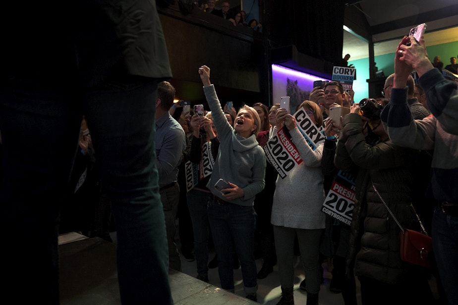 caption: Supporters cheer for presidential candidate Cory Booker during a 'Grassroots Happy Hour' on Tuesday, December 17, 2019, on Belmont Avenue East in Seattle. 