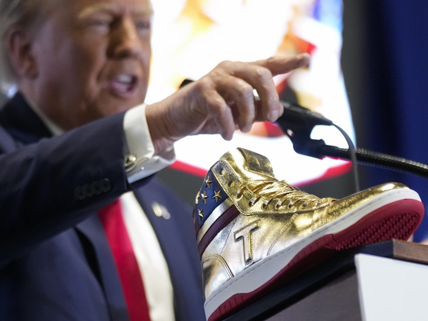 caption: Republican presidential candidate Donald Trump unveils his golden high-tops on Saturday at Sneaker Con Philadelphia, an event popular among sneaker collectors.