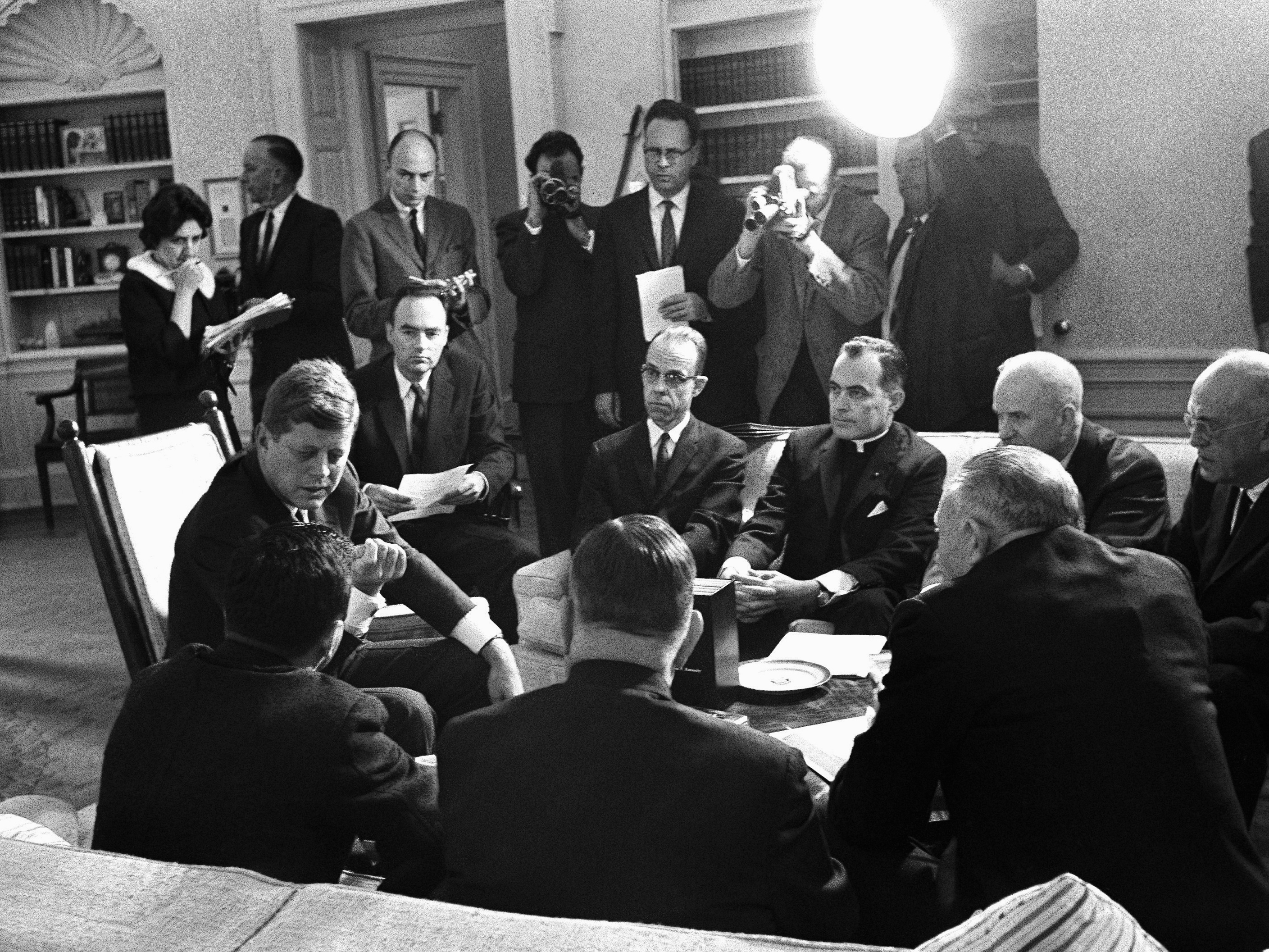 caption: President John F. Kennedy and members of the Civil Rights Commission pose during a White House conference in Washington in 1961. Harris Wofford, who died Monday at age 92, is seated to Kennedy's left.