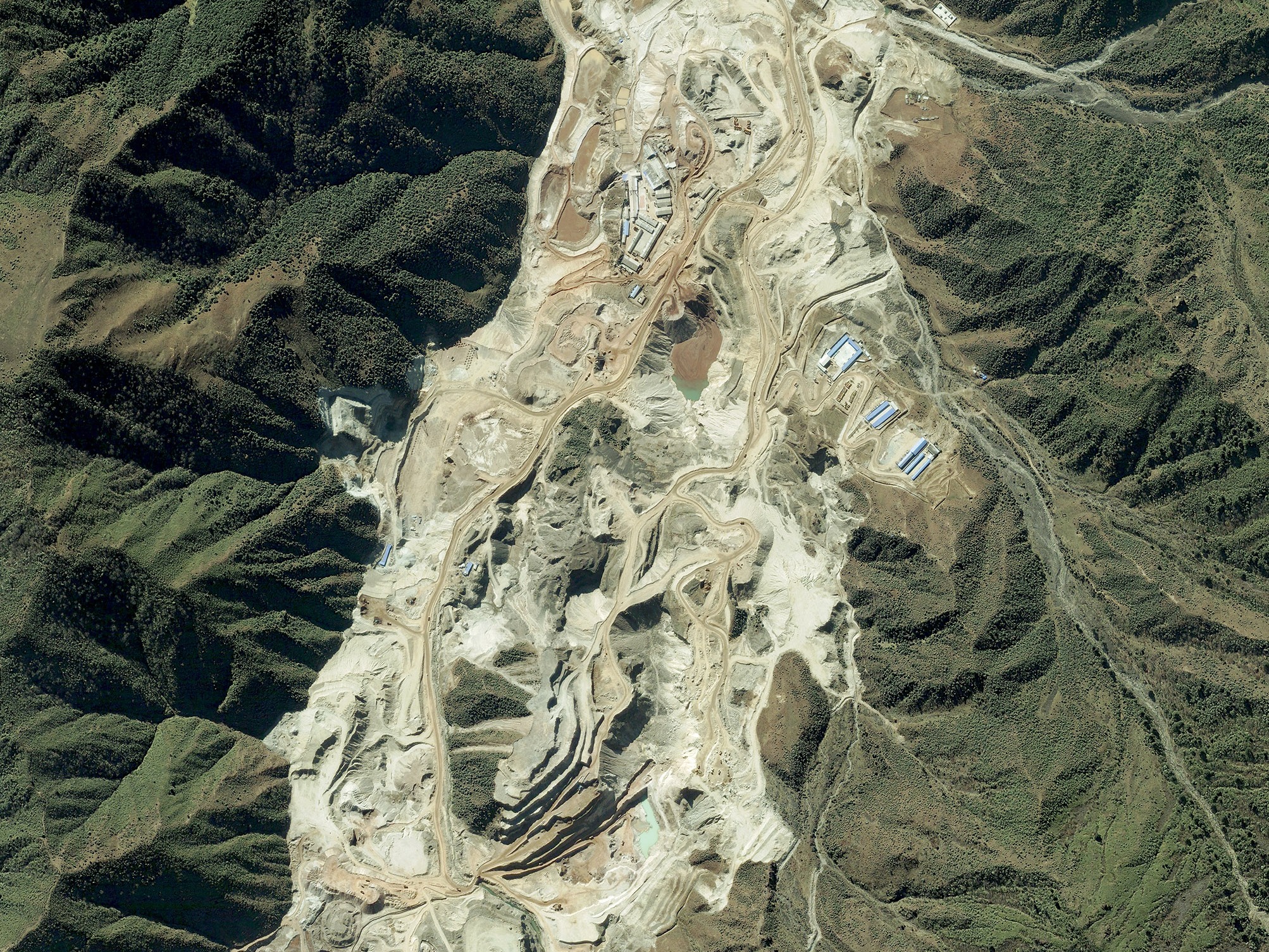 caption: This is a satellite image collected on Nov. 13, 2012, of the Maoniuping Mine, one of China's largest rare earth elements mines, located near Mianning, Sichuan province, China.