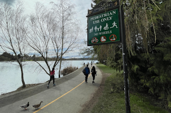 caption: A sign at Seattle's Green Lake Park tells visitors that wheels are not welcome on the lakeside trail.