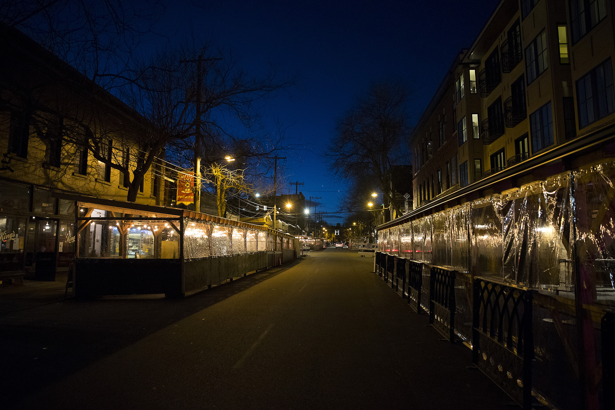 caption: Outdoor dining areas are set up along Ballard Avenue Northwest on Monday, March 22, 2021, in Seattle. Beginning Monday, restaurants, retailers, and fitness centers can open with up to 50% capacity as Washington's 39 counties move into the third phase of Gov. Jay Inslee's reopening plan. 