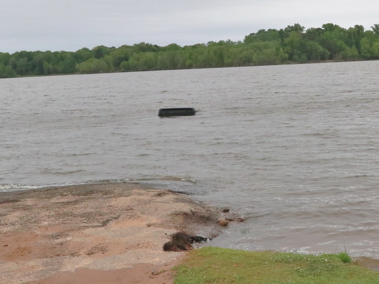 caption: This black Jeep was almost entirely submerged in Lake o' the Pines in Marion County, Texas. It wasn't until a tow truck started to pull it from the water that a woman was spotted inside.