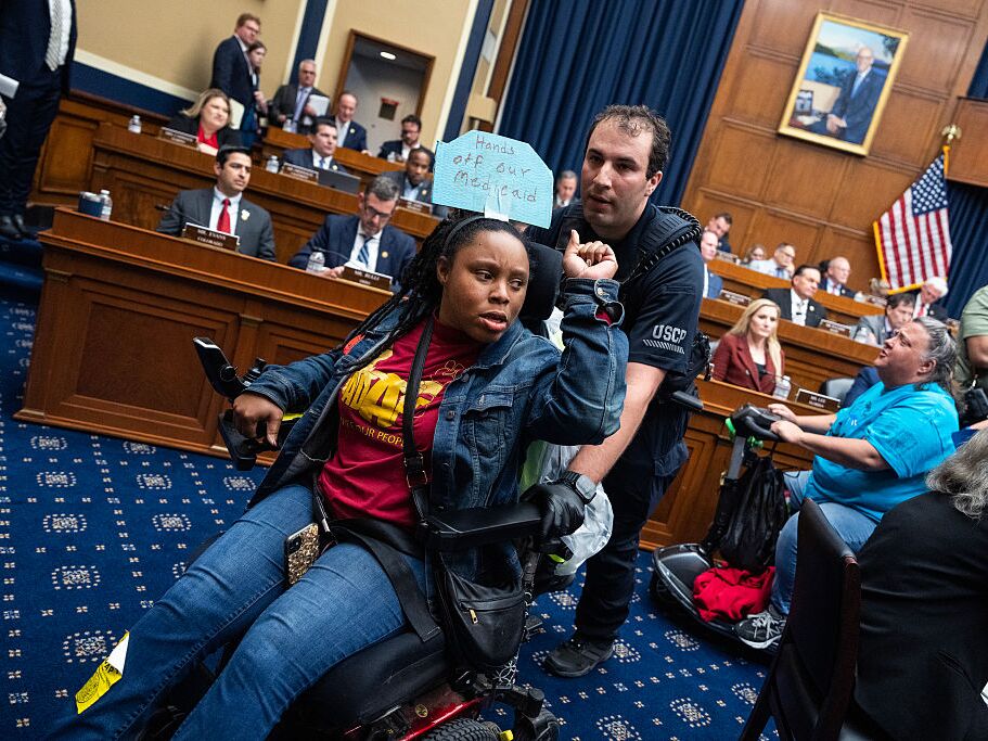 caption: Demonstrators calling for preservation of Medicaid funding, are removed from the House Energy and Commerce markup of the budget resolution in Rayburn building on May 13.