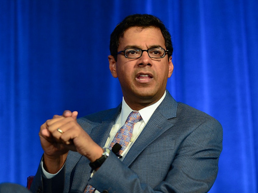 caption: Dr. Atul Gawande delivers a speech in 2015. In January 2022, he became the head of the U.S. Agency for International Development's work in global health.