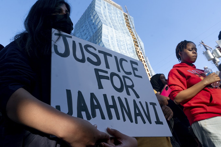 caption: A protester holds a sign calling for justice as people protest Thursday, Sept. 14, 2023, in Seattle after body camera footage was released of a Seattle police officer joking about the death of Jaahnavi Kandula, a 23-year-old woman hit and killed in January by officer Kevin Dave in a police cruiser. 