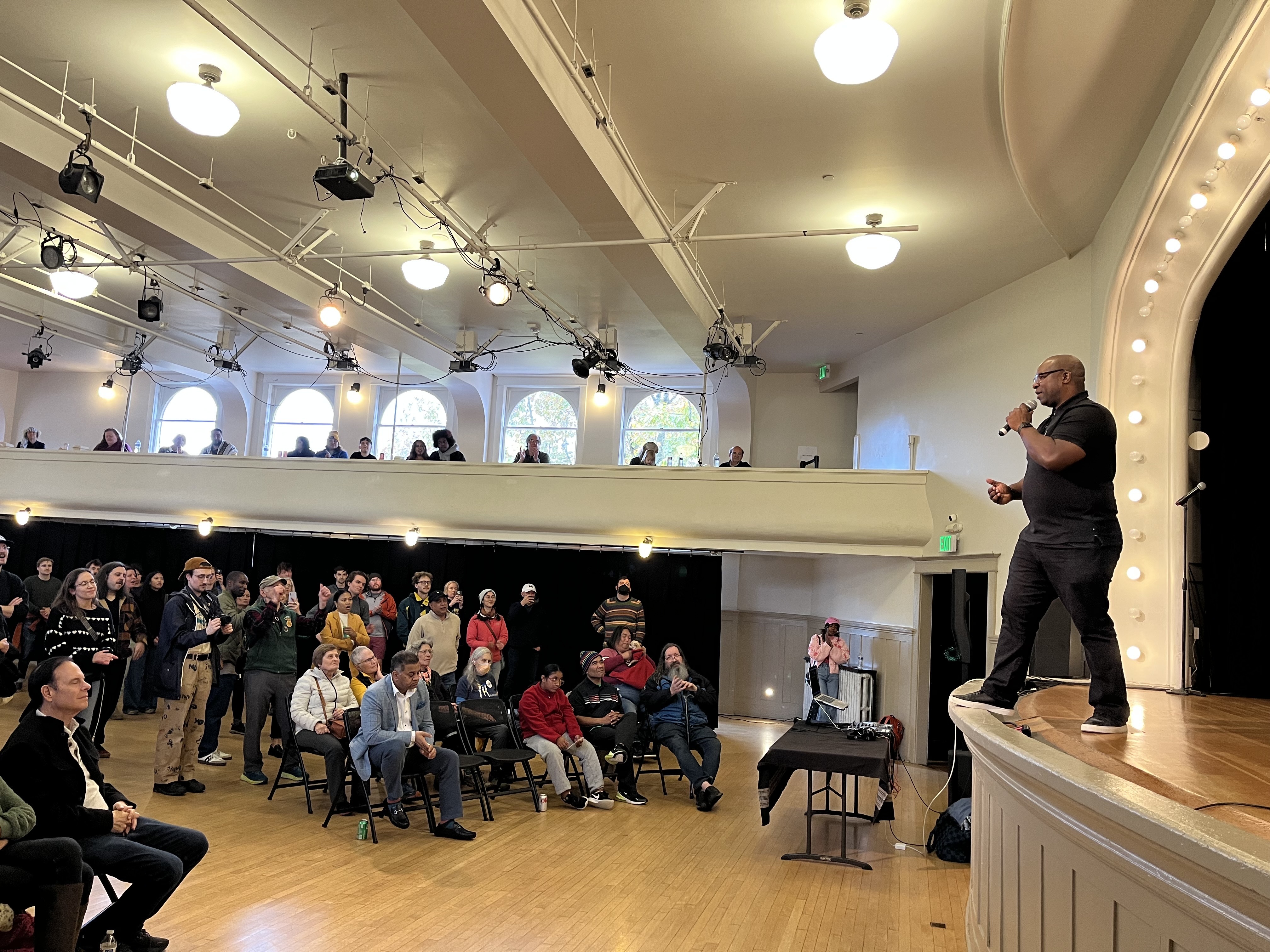 caption: Former U.S. Rep. Jamaal Bowman addresses a rally in support of Katie Wilson for mayor at Washington Hall on Oct. 26, 2025.