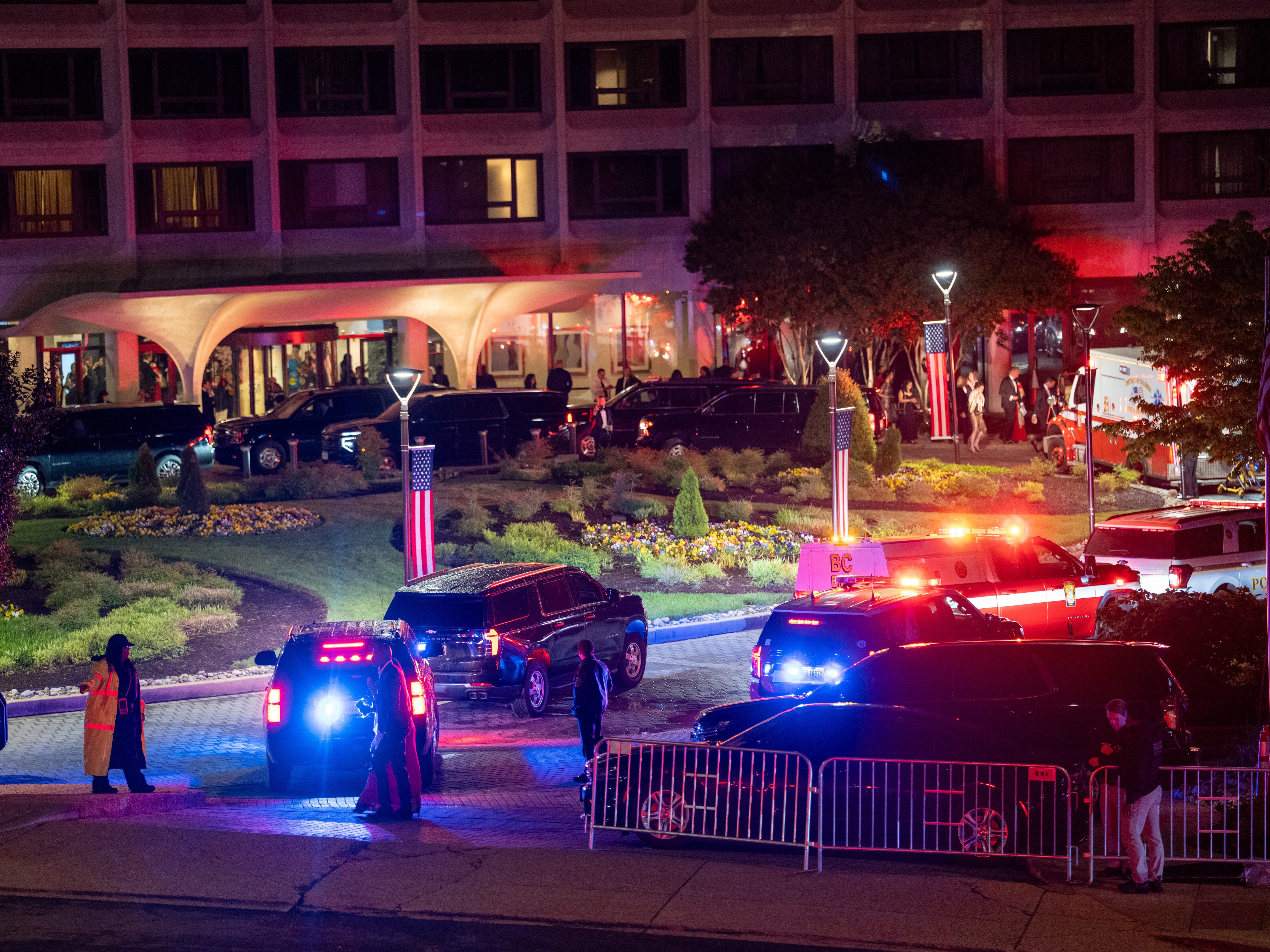 caption: Law enforcement surrounds the Washington Hilton Hotel where shots were fired near the White House Correspondents' Association Dinner featuring President Donald Trump in Washington, D.C., on April 25.