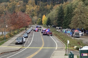 caption:  Police tape blocks access to Deschutes Parkway on the edge of Washington's Capitol Campus on Wednesday, October 27. The Washington State Patrol was investigating a midday shooting that sent one man to the hospital. It was the third violent crime in the same area in the month of October. 