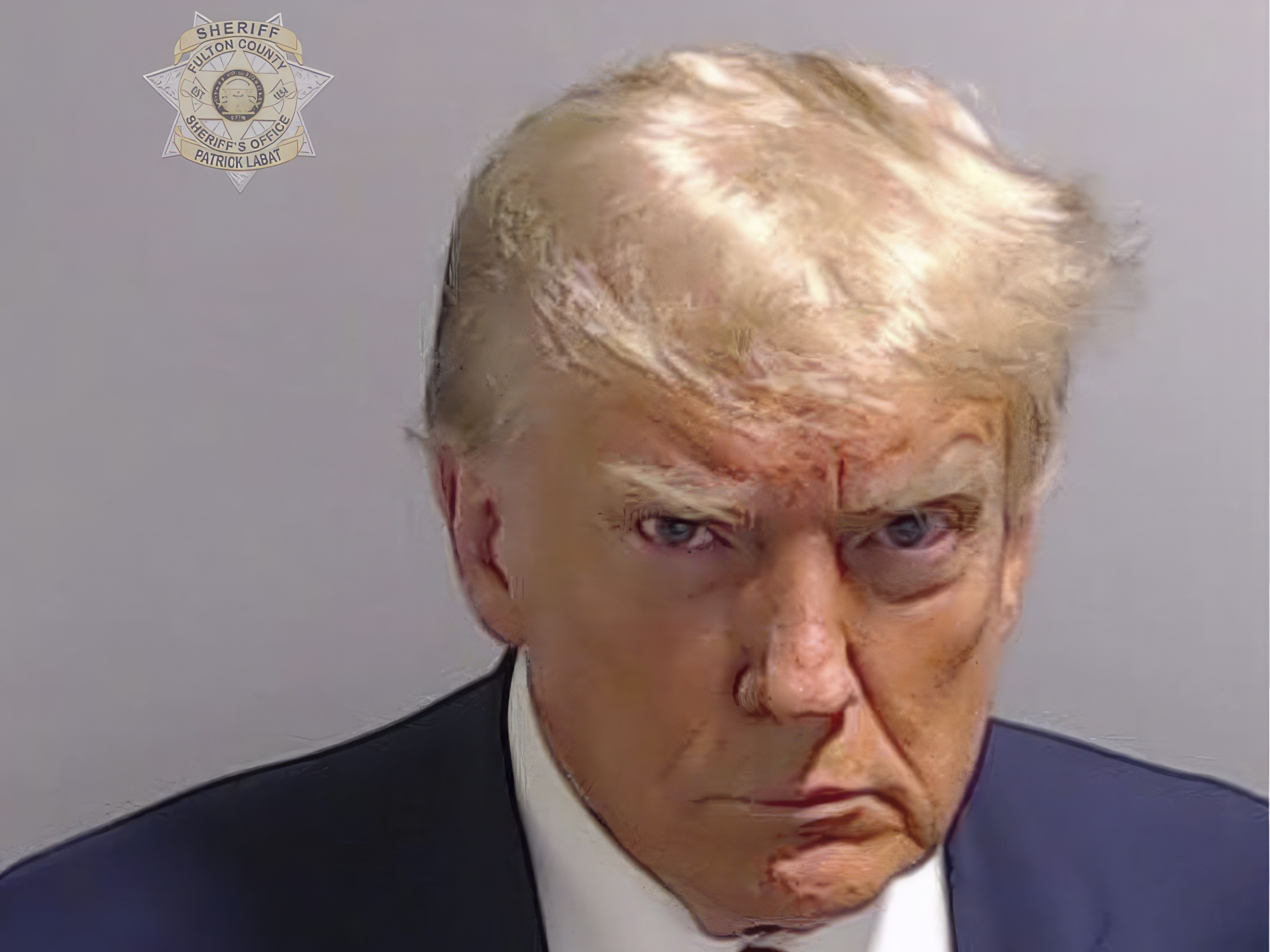 caption: This booking photo provided by Fulton County Sheriff's Office shows former President Donald Trump on Thursday after he surrendered and was booked at the Fulton County Jail in Atlanta.