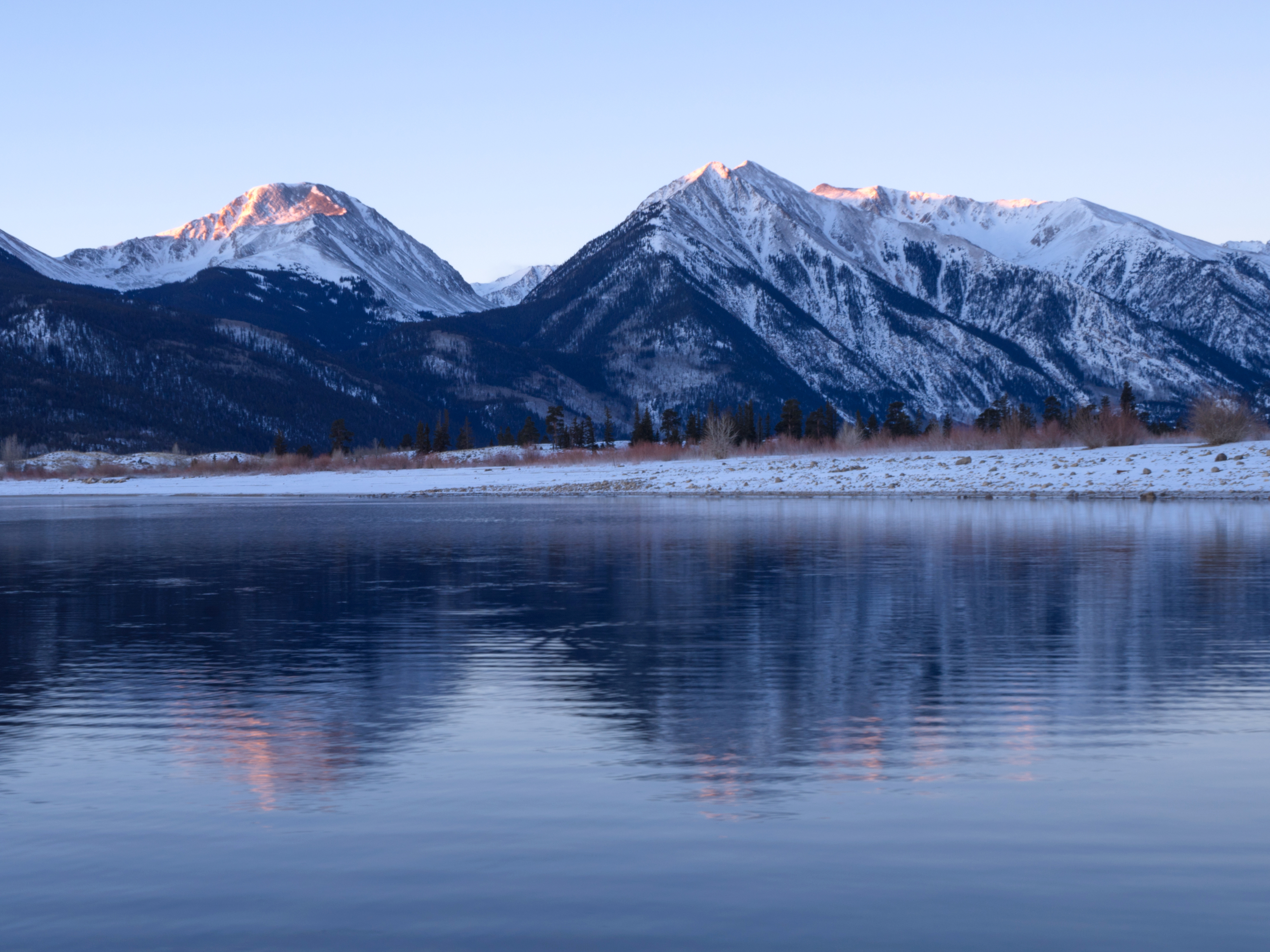 caption: Mount Elbert, the tallest peak in the Rocky Mountains, is seen here reflected in Twin Lakes near Leadville, Colorado. A hiker on the mountain didn't answer rescuers' phone calls because the number was unfamiliar.