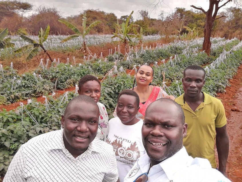 caption: Noah Nasiali-Kadima, foreground, takes a selfie with members of the Africa Farmers Group during a tour of a member's farm in Machakos County, Kenya.