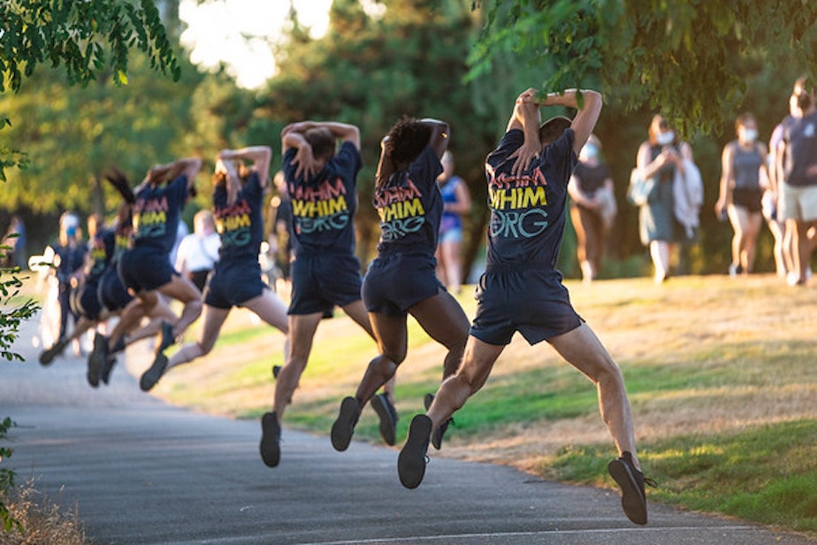 caption: Whim W'Him company members perform a live, socially-distanced pop-up dance on the Elliott Bay waterfront