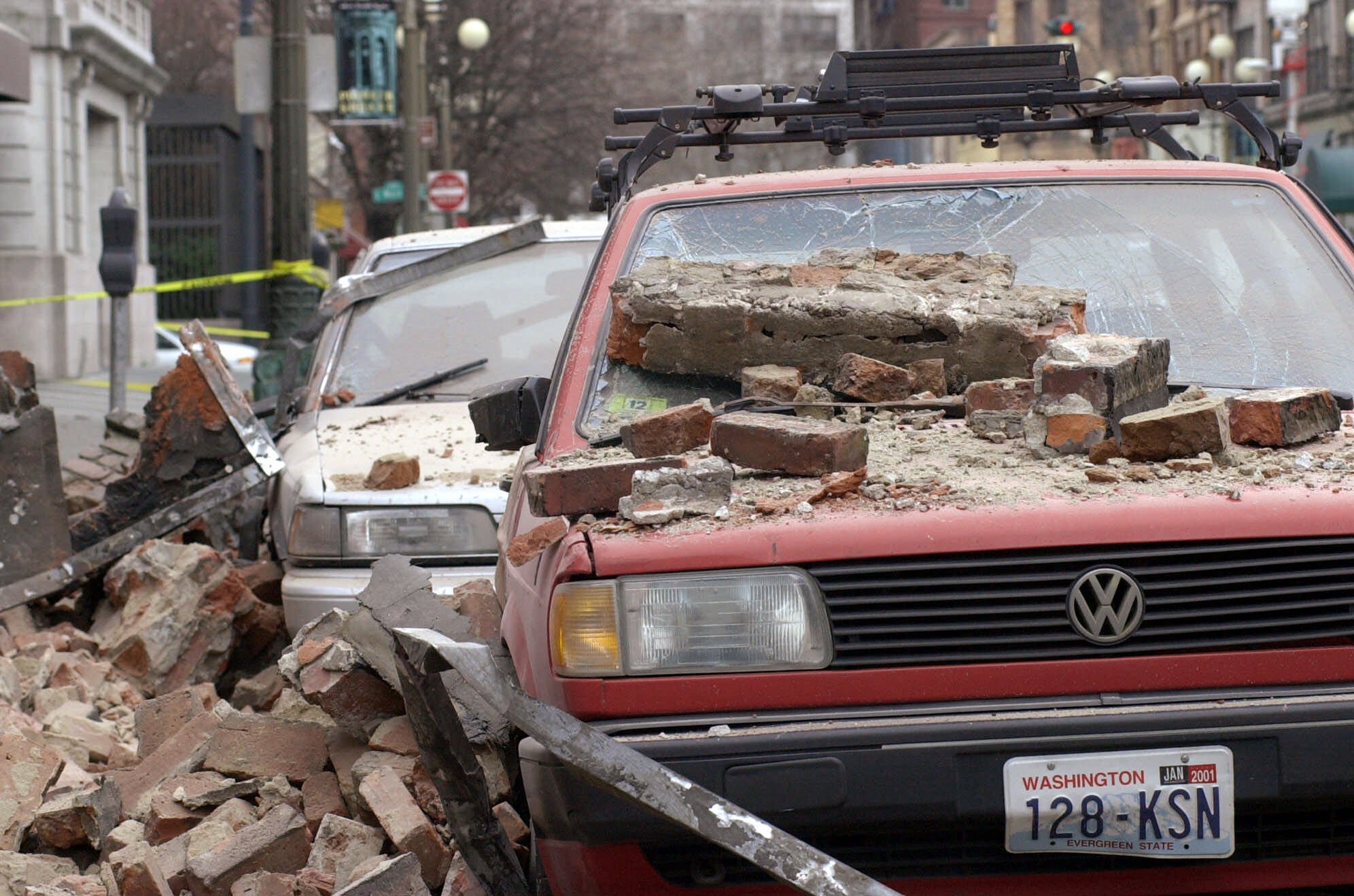 caption: Bricks that fell from an earthquake cover parked cars in Seattle's Pioneer Square district, Wednesday, Feb. 28, 2001 after a magnitude 6.8 earthquake which damaging buildings and roads, and closing Seattle's two airports.