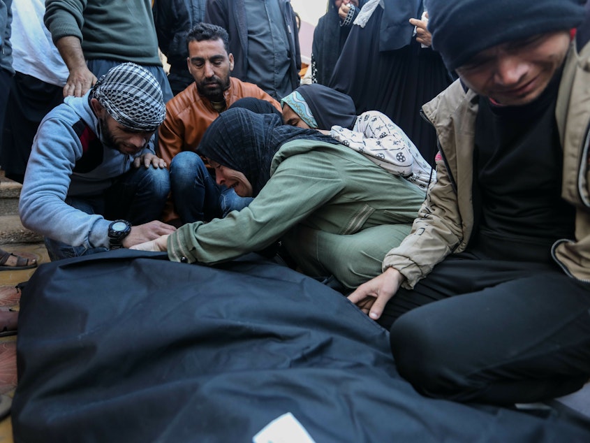 caption: People mourn as they collect the bodies of Palestinians killed in an airstrike on Monday in Khan Yunis, Gaza. The United Kingdom, France and Germany are the latest countries to call on Israel to reach a "sustainable truce" after more than two months of war in Gaza.