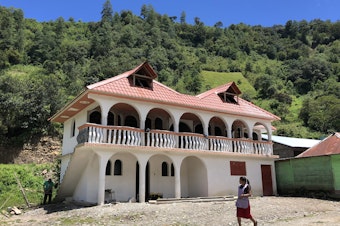 caption: Castillos<em>, </em>or castles, in the the Guatemalan villages of Huehuetenango that were built with money earned in the United States.
