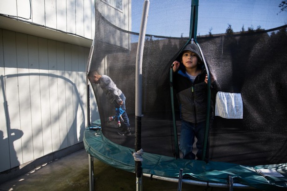 caption: <p>Romeo, 7, left, and his brother Rey play on the trampoline in the backyard of their family home in Vancouver, Wash., Saturday, March 2, 2019.</p>