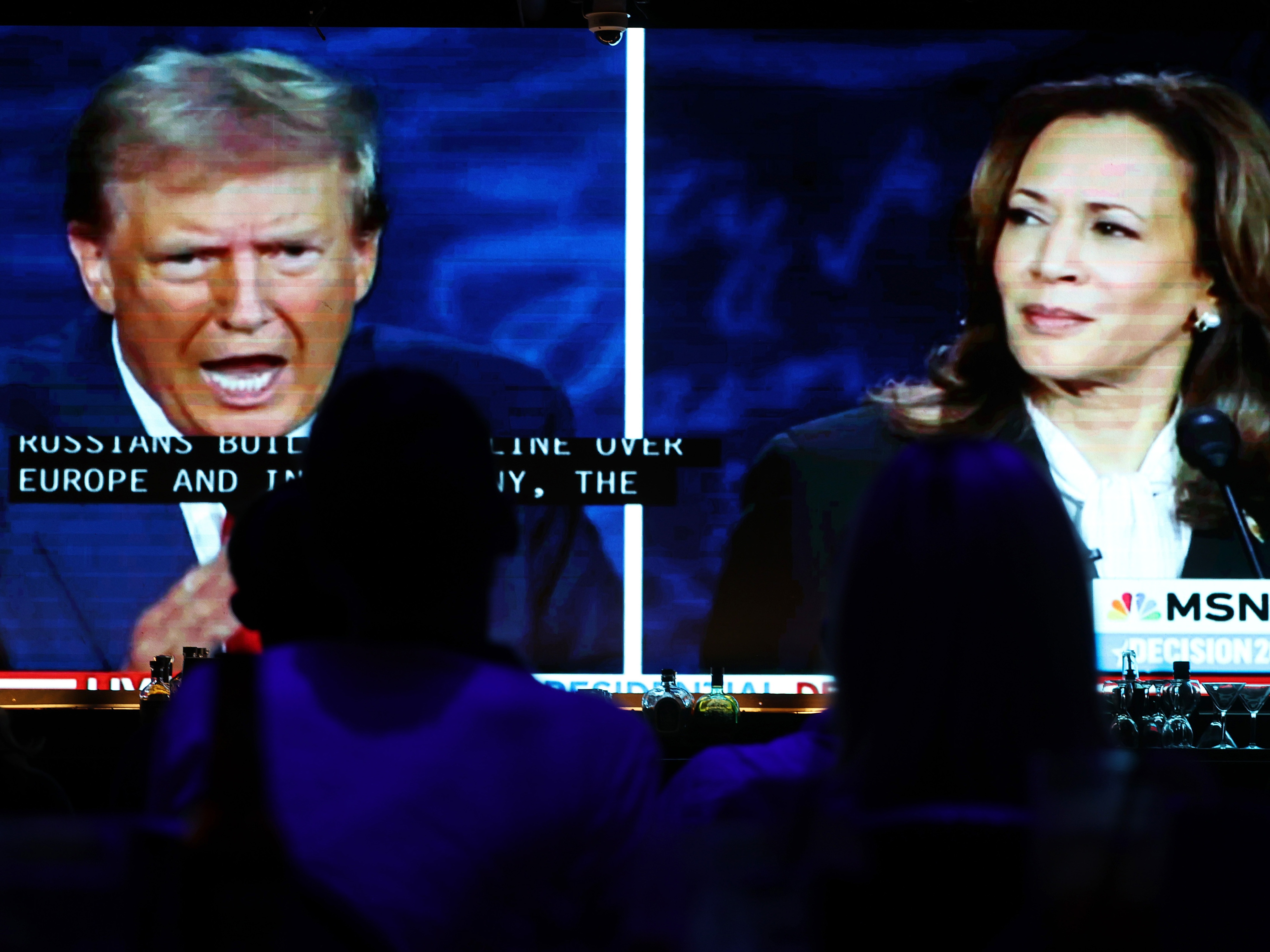caption: People watch the ABC News presidential debate in West Hollywood, Calif.