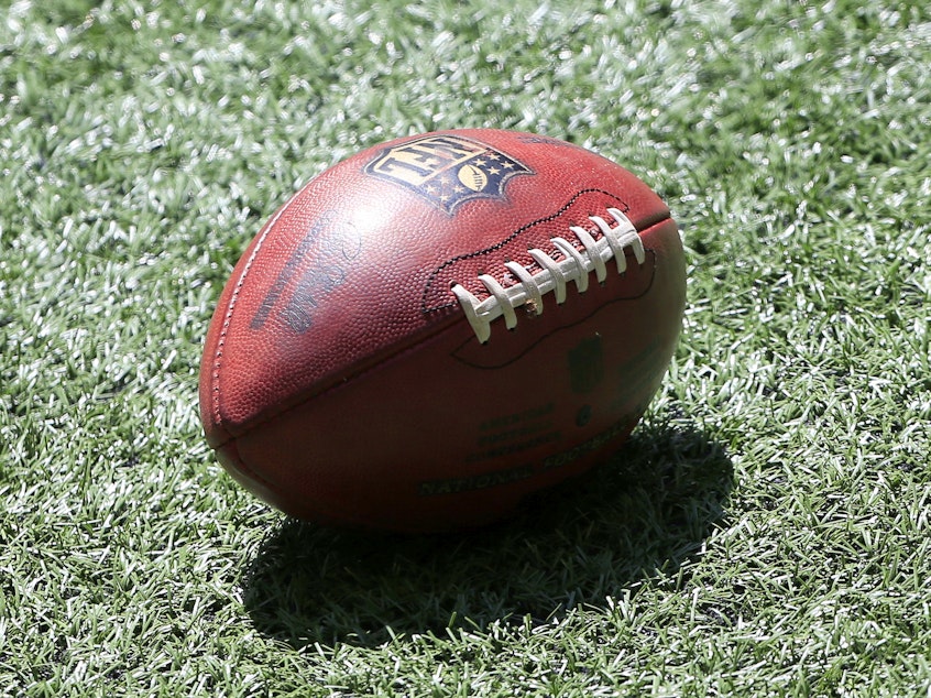 caption: A football lies on the turf prior to the NFL Week 1 game between the Atlanta Falcons and the Seattle Seahawks on September 13, 2020.