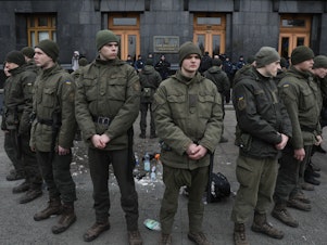 caption: National Guards surround the place where a person immolated himself earlier in Kyiv, Ukraine, on Feb. 26, 2020. A man doused himself with a flammable liquid and set himself on fire in front of Presidential Office.