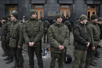 caption: National Guards surround the place where a person immolated himself earlier in Kyiv, Ukraine, on Feb. 26, 2020. A man doused himself with a flammable liquid and set himself on fire in front of Presidential Office.