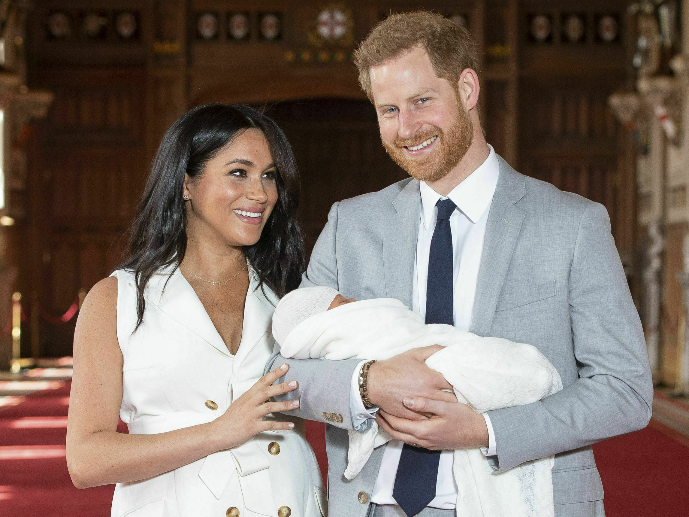 caption: Britain's Prince Harry and Meghan, Duke and Duchess of Sussex, hold their newborn son in St. George's Hall at Windsor Castle on Wednesday. Archie Harrison Mountbatten-Windsor was born Monday morning.