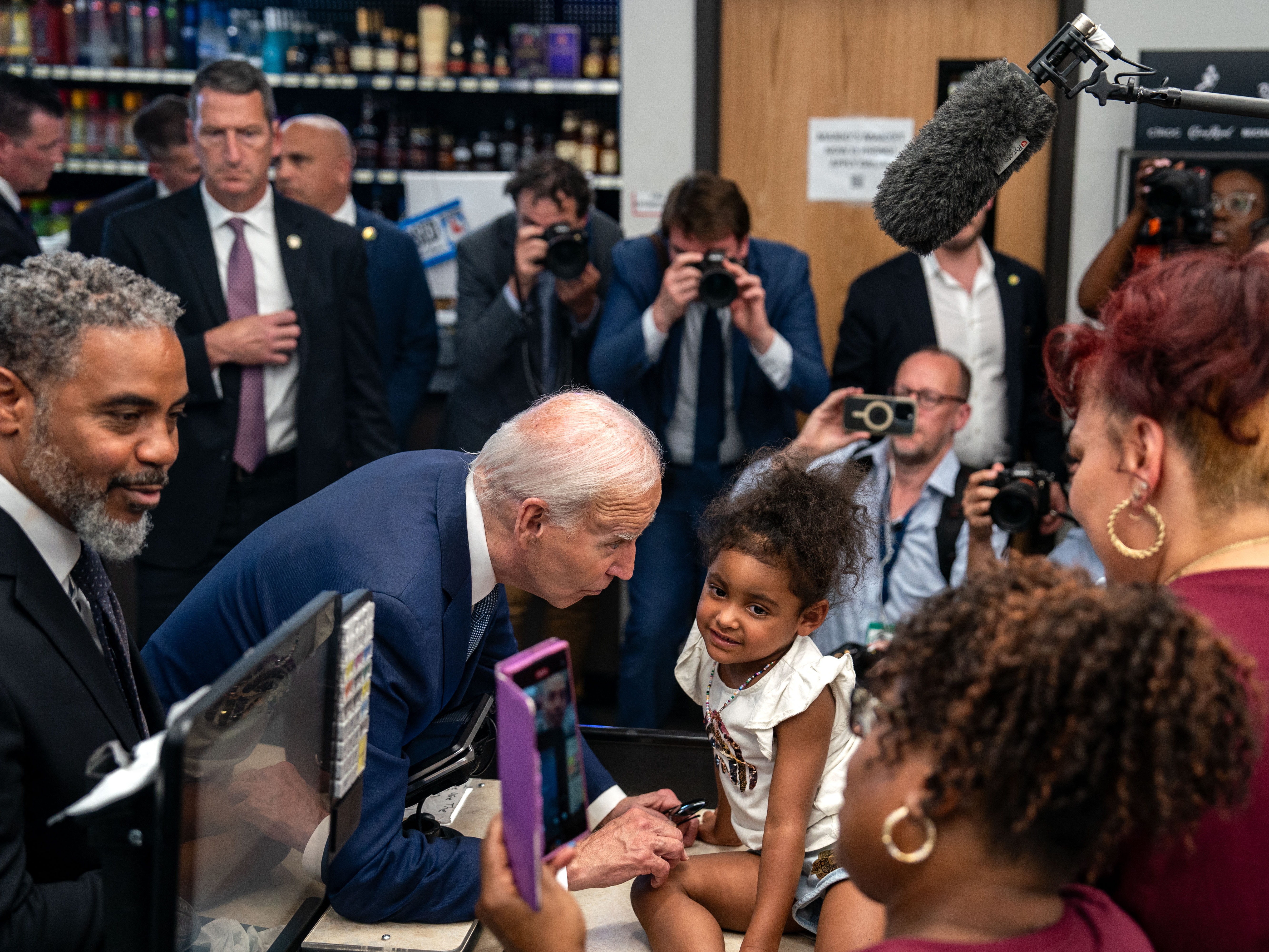 caption: President Biden does some retail campaigning at Mario's Westside Market in Las Vegas, alongside Rep. Steven Horsford, D-Nev., on July 16. A case of COVID took Biden off the trail the following day.