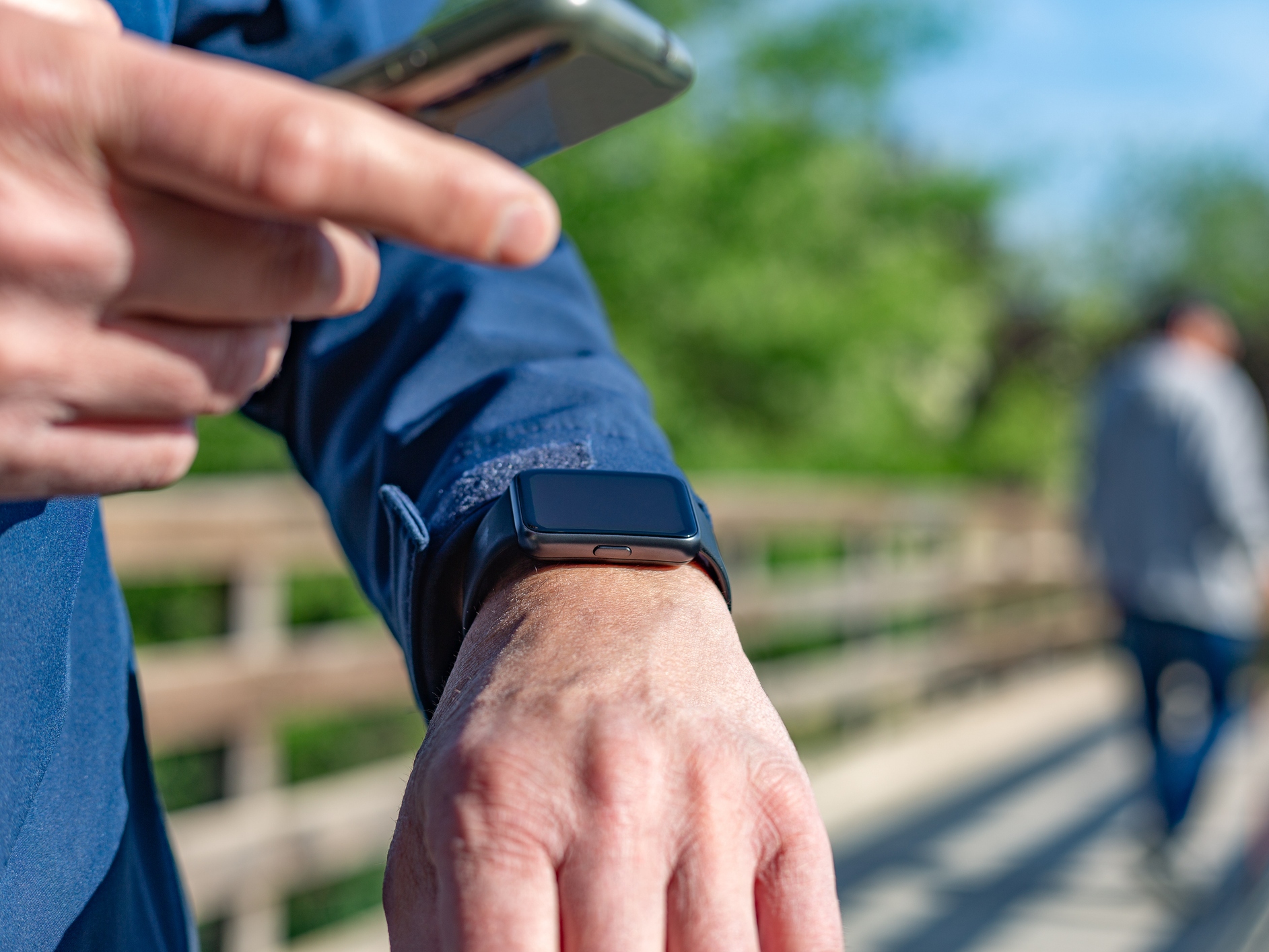 caption: Madrid, Spain. Mature man using technology for his daily routines. For example, counting the steps he takes each day.