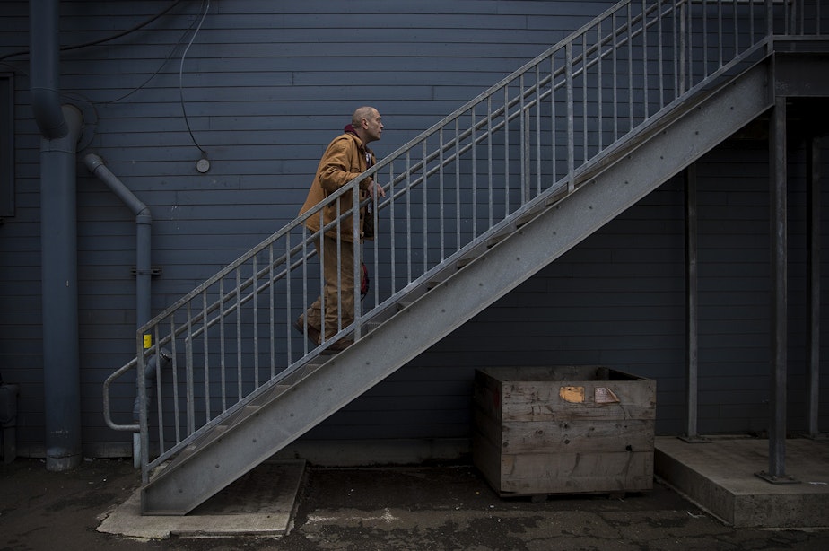 caption: Kevin Boggs walks up a set of stairs to the locker room on Friday, December 14, 2018, where he works at Vigor's ship yard in Seattle.