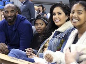 caption: Basketball great Kobe Bryant (from left), daughter Gianna, wife Vanessa and daughter Natalia are seen before an NCAA college women's basketball game in 2017 in Los Angeles. Vanessa Bryant says Nike is making, without her consent, a shoe she designed in honor of her late daughter, Gianna.