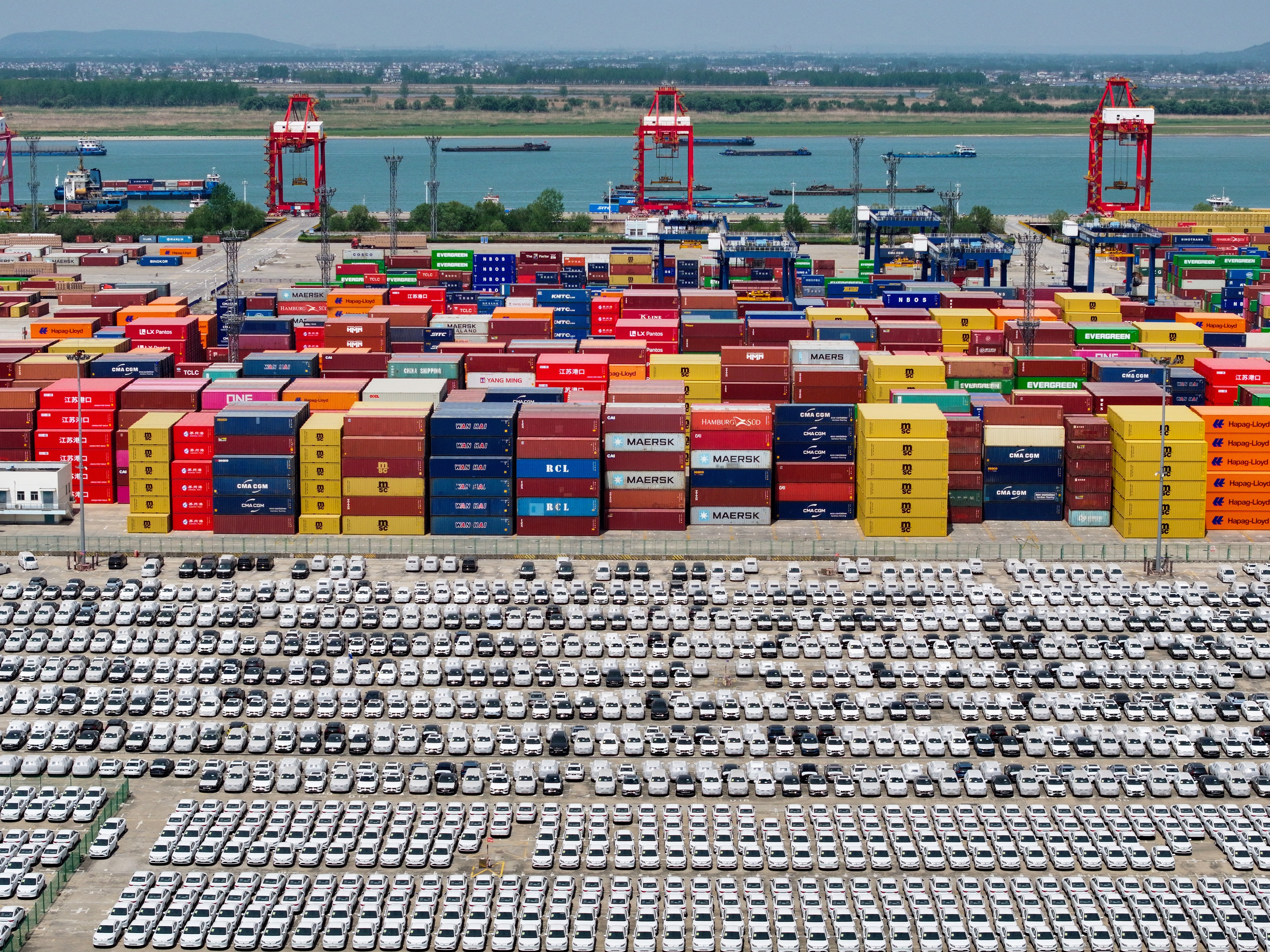 caption: Chinese-made cars are lined up in rows at the port in Nanjing, in China's eastern Jiangsu province, on April 16 as they wait to be loaded onto ships for export.