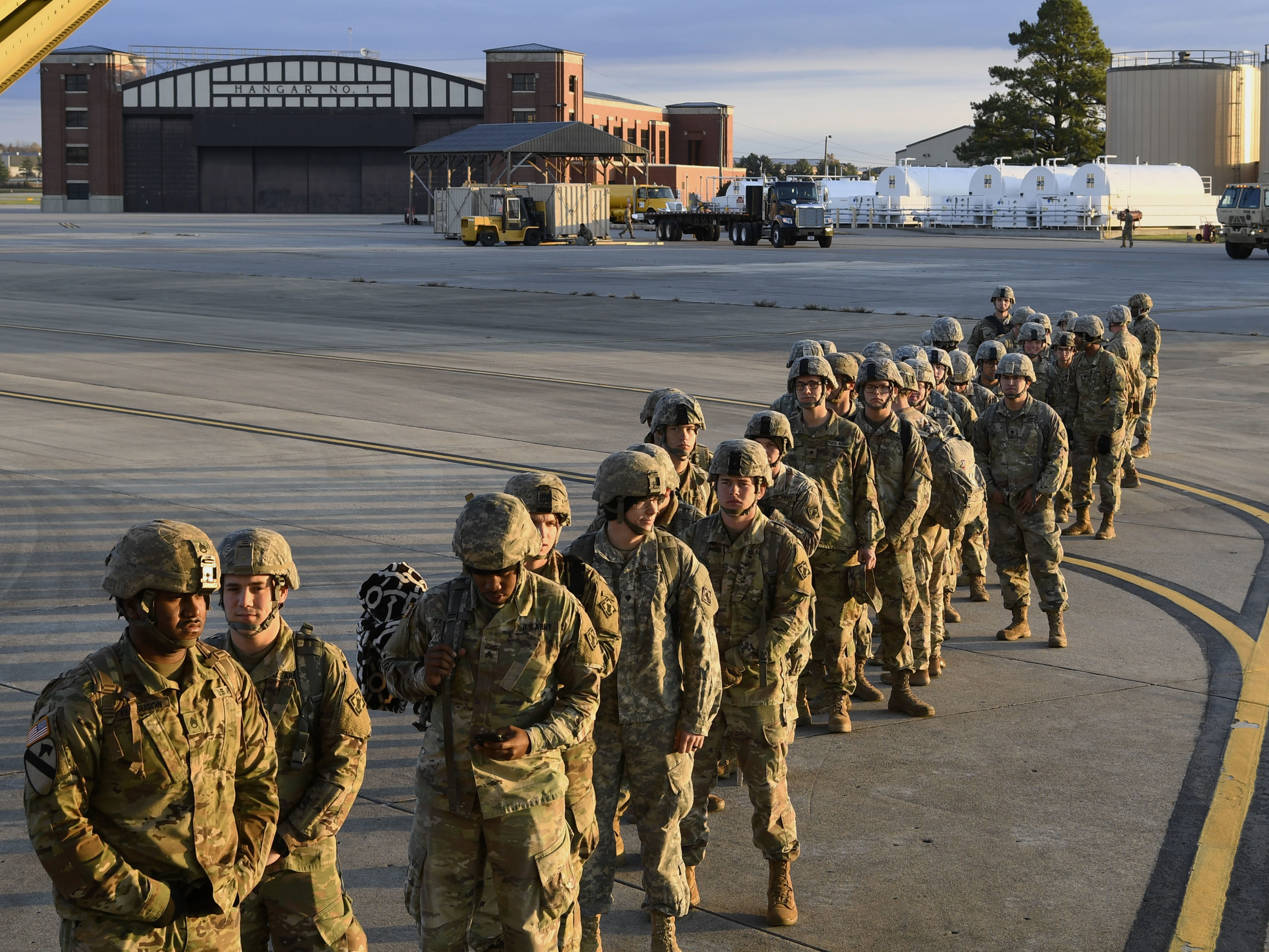 caption: Soldiers from the 541st Sapper Company headed to the southern U.S. border prepare to board an air transport plane on Tuesday in Ft. Knox, Ky.