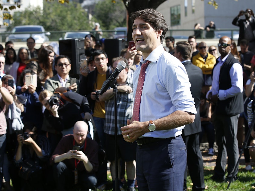 caption: Canadian Prime Minister Justin Trudeau addresses the media Thursday in Winnipeg, Canada, regarding photos in which he is seen wearing dark makeup.