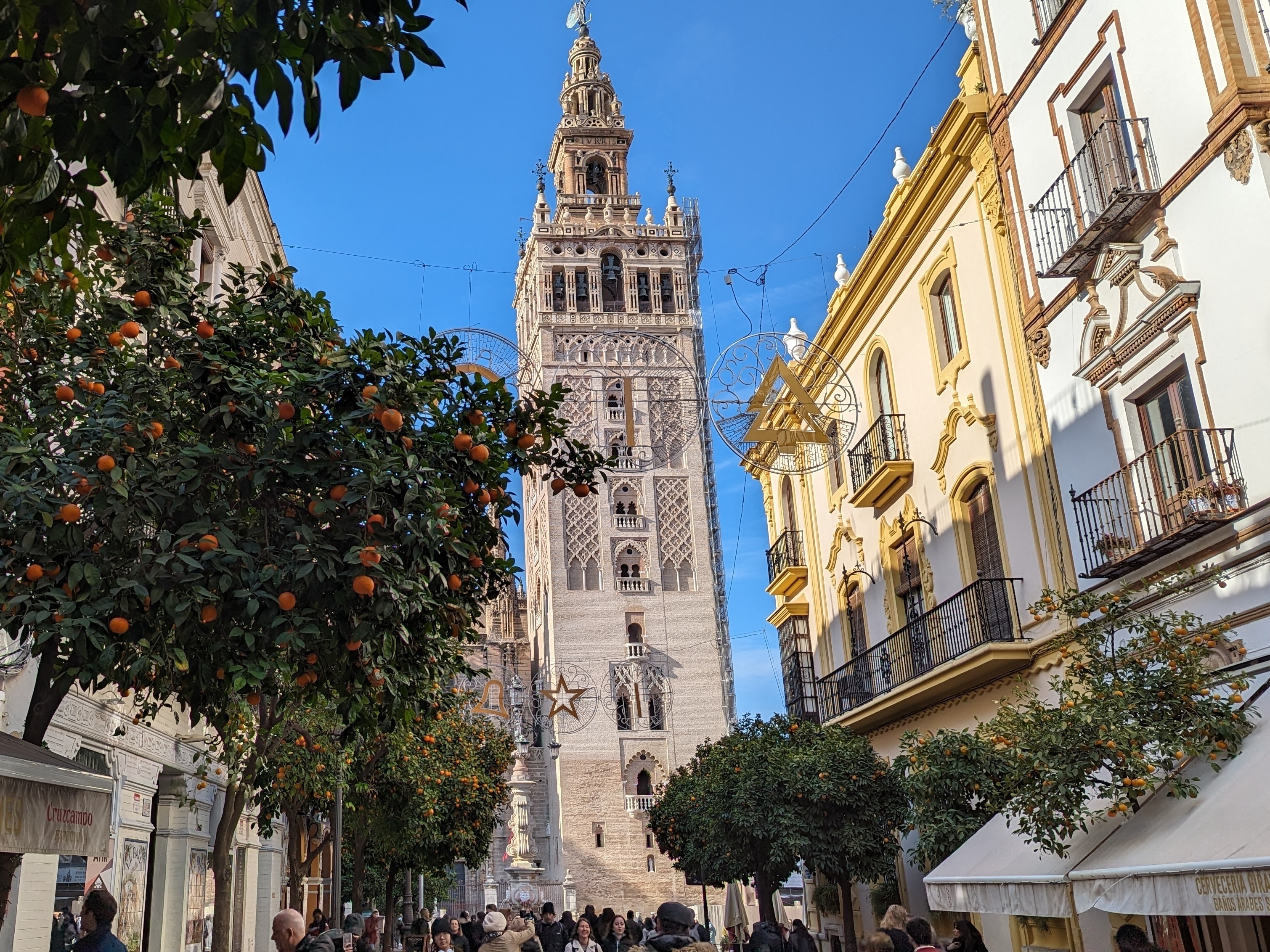 caption: The Giralda tower, part of the cathedral of Seville, viewed from Mateos Gago street.