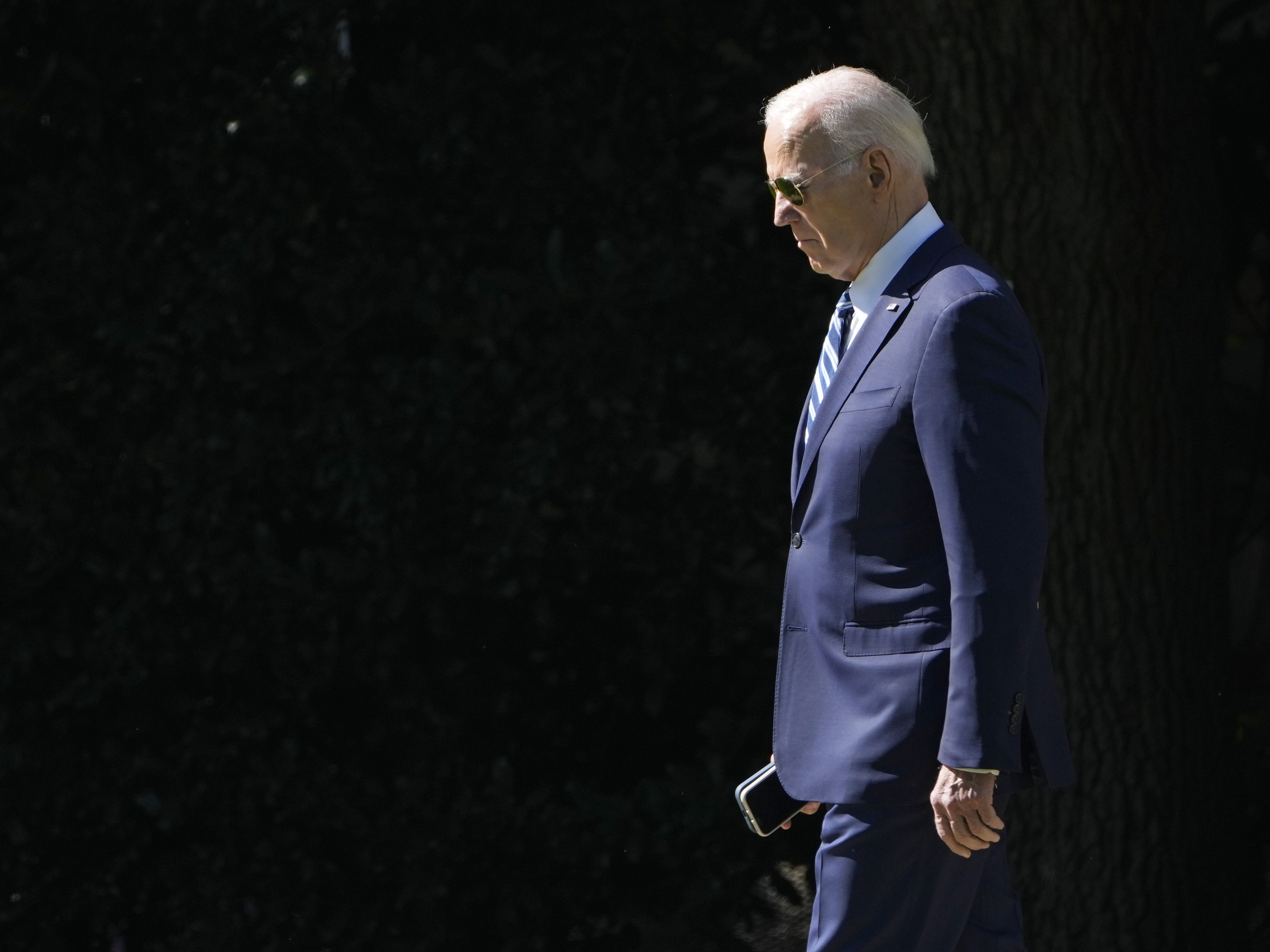 caption: President Biden walks toward Marine One on the South Lawn of the White House on Fri., Oct. 13, 2023.