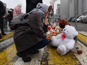 caption: A woman mourns at a makeshift memorial in front of the Crocus City Hall on Saturday, a day after a gun attack in Krasnogorsk, outside Moscow, killed at least 133 people.
