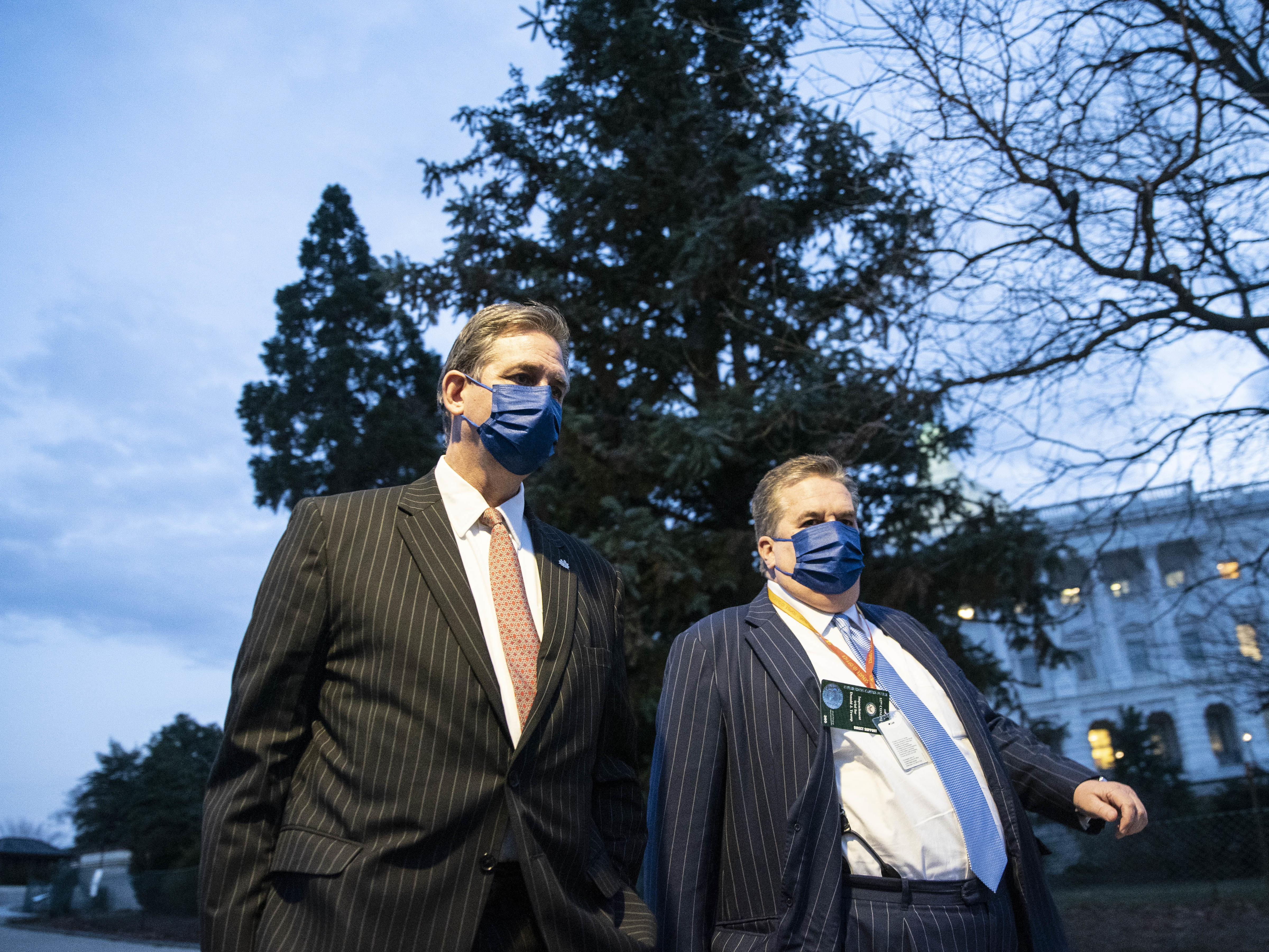 caption: Bruce Castor (left), defense attorney for former President Donald Trump, departs the Capitol following the first day of the impeachment trial.