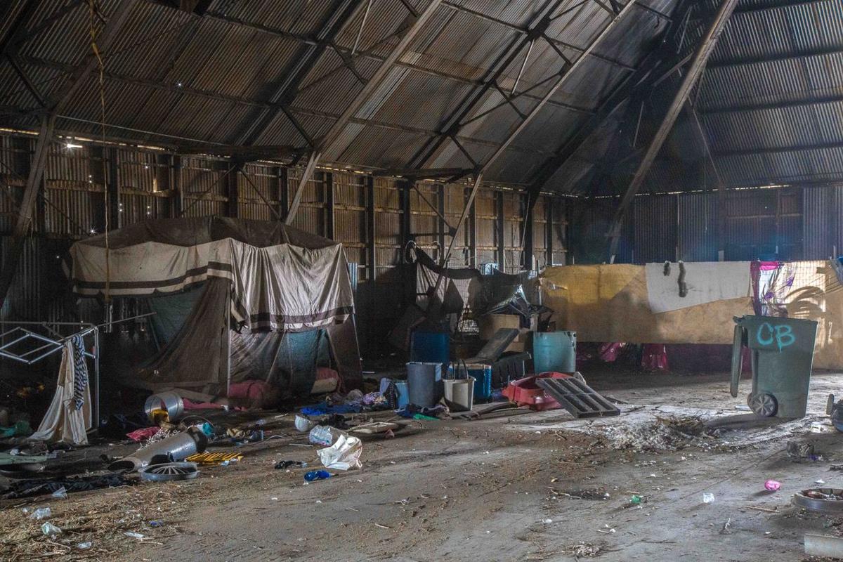 caption: An abandoned factory warehouse serves as shelter for some homeless people in Bakersfield, California. (Photo by Michael K. Chadburn)