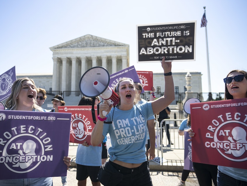caption: Anti-abortion activists rally in front of the U.S. Supreme Court on June 6.