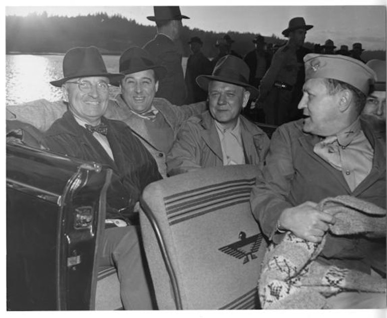 caption: President Harry S. Truman goes for a car ride during a Puget Sound fishing trip. From left to right, Truman, Sen. Warren G. Magnuson, Gov. Monrad C. Wallgren, and Maj. Gen. Harry H. Vaughan.