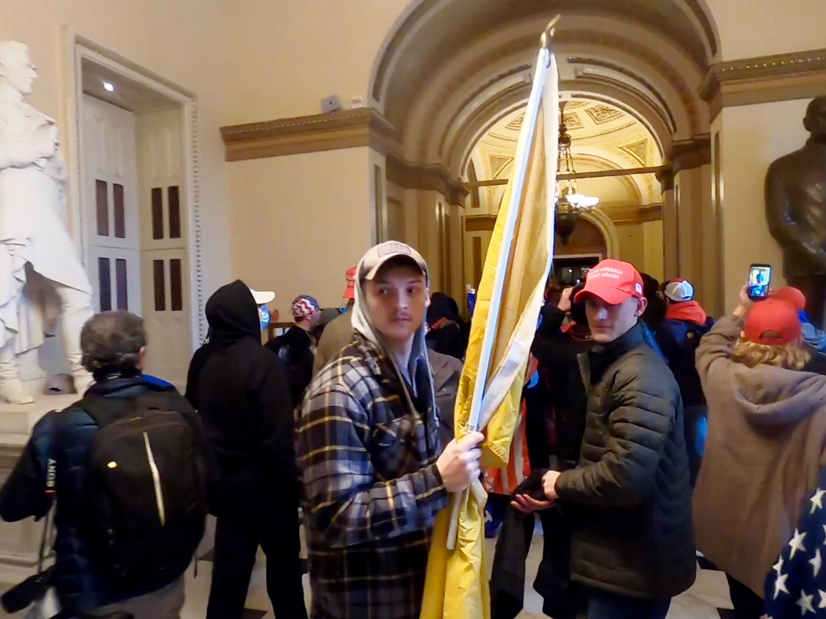 caption: Josh Abate and Micah Coomer inside the U.S. Capitol on Jan. 6, 2021.