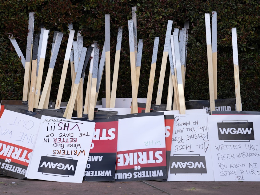 caption: Placards are gathered together at the close of a picket by members of The Writers Guild of America outside Walt Disney Studios, Tuesday, May 2, 2023, in Burbank, Calif.