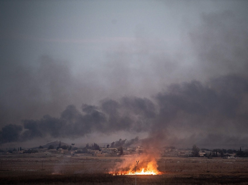 caption: Smoke rises from the Syrian town of Tal Abyad on Thursday on the second day of Turkey's military operation against Kurdish forces. President Trump's decision to pull back U.S. forces from the area has been viewed as giving Turkey a green light for the operation and opened him up to condemnation from within the GOP.