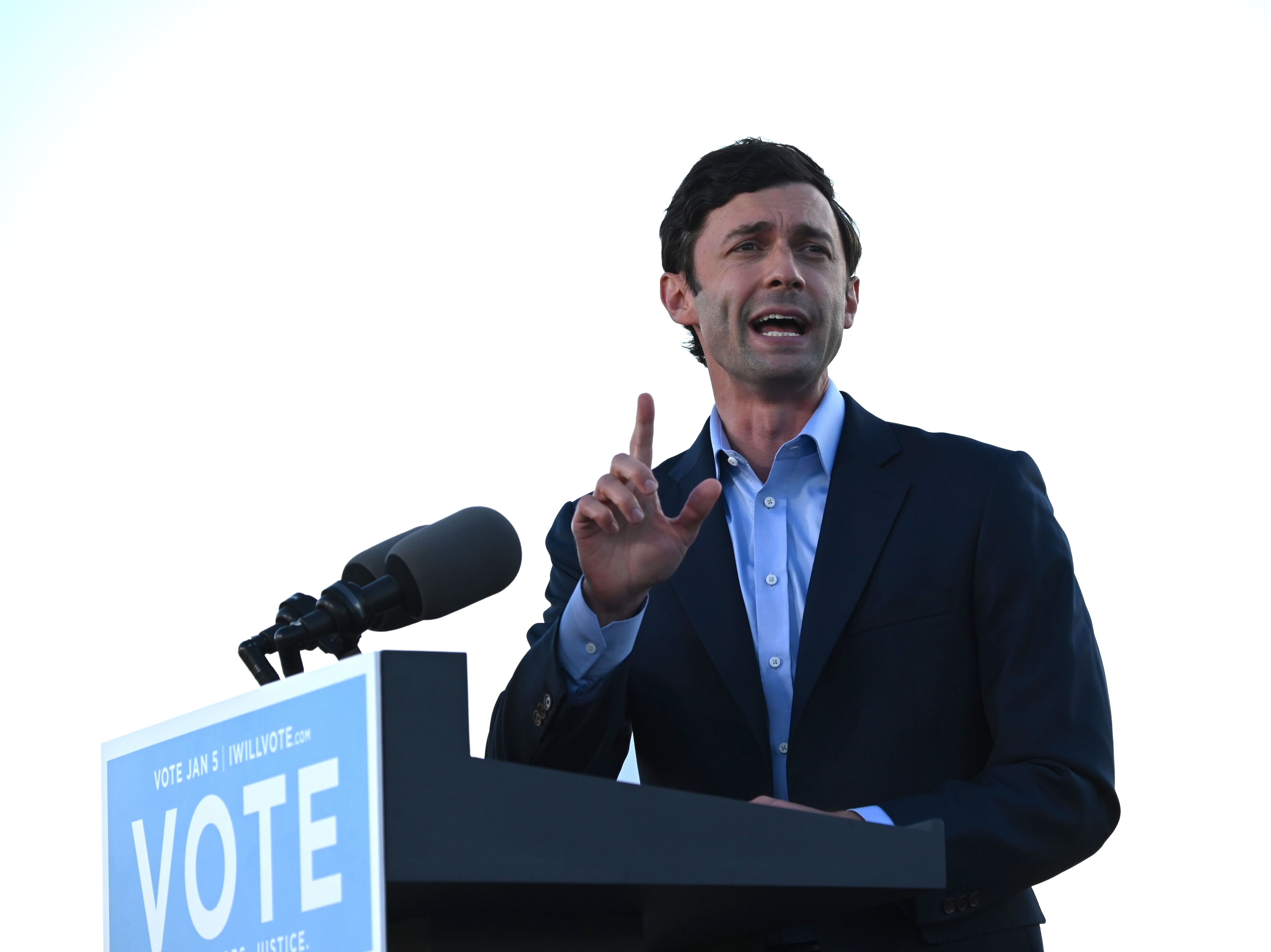 caption: Democrat Jon Ossoff speaks at a rally outside of Center Parc Stadium in Atlanta on Monday.