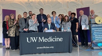 caption: Gov. Jay Inslee smiles during what may be his last ever bill-signing ceremony Friday at the University of Washington’s behavioral health teaching hospital in Seattle.