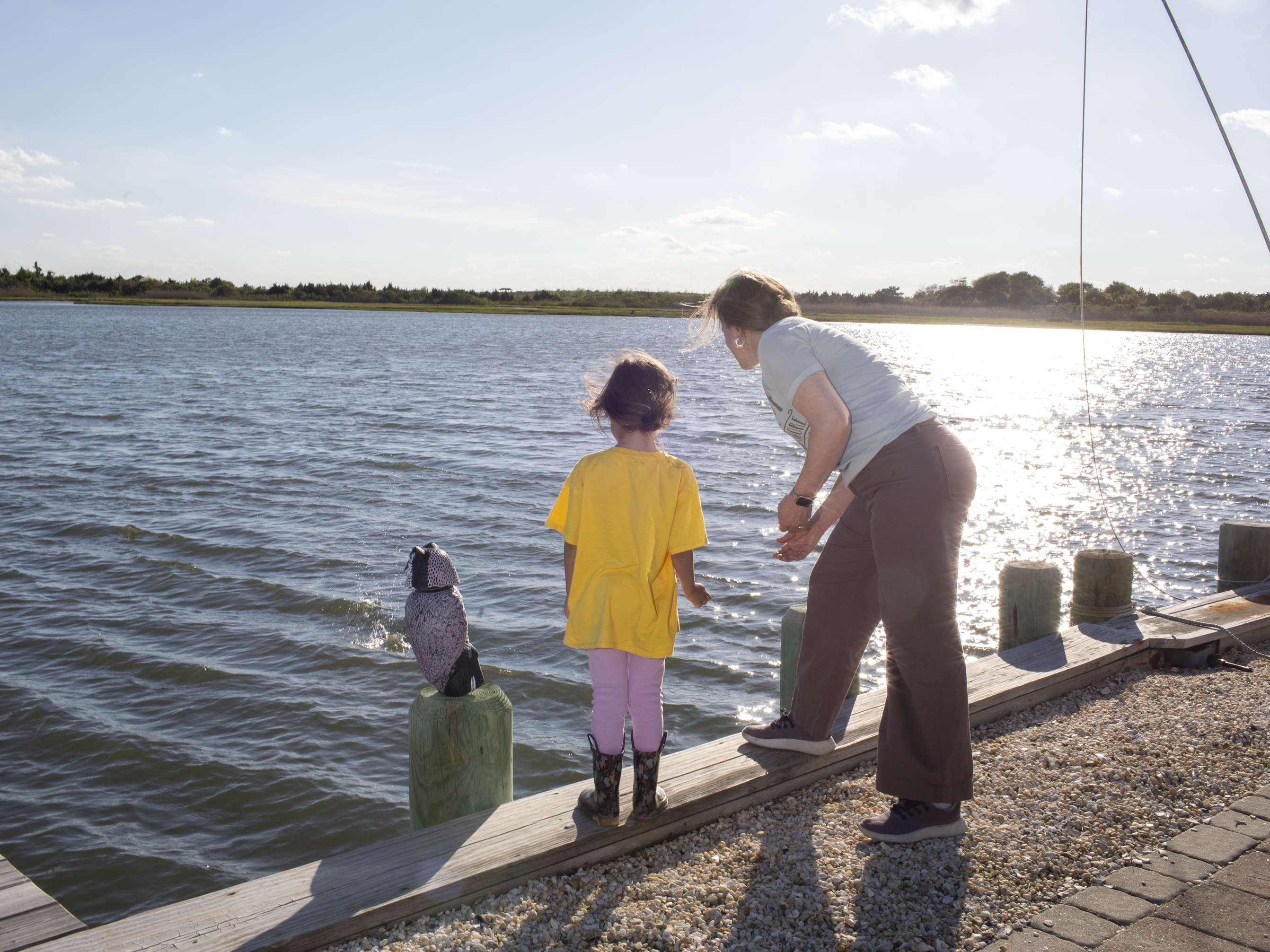 caption: Amanda Devecka-Rinear and her daughter can skip rocks from their front yard. Devecka-Rinear's home on a tiny island in Stafford Township, N.J., escaped damage during Superstorm Sandy because it happened to be raised for maintenance work. "It was elevation that saved this house," she says.