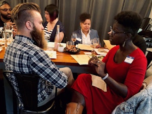 caption: Curiosity Club member Jeffrey Howard talks with KUOW producer Adwoa Gyimah-Brempong at The Cloud Room in Seattle for Queeriosity Club. Fellow Club members Timothy Bardlavens (far left), Ginger Chien (center) and Mellina White Cusack (right) chat in the background. June 6, 2019. 