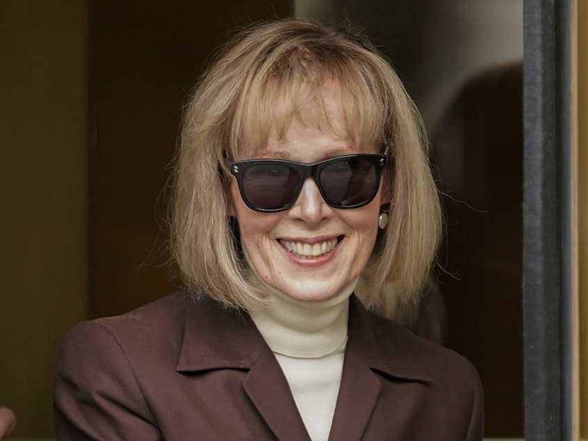 caption: E. Jean Carroll walks out of federal court in Manhattan, May 9, 2023, in New York. A federal judge has denied former President Donald Trump's request for a new trial in the E. Jean Carroll defamation case.