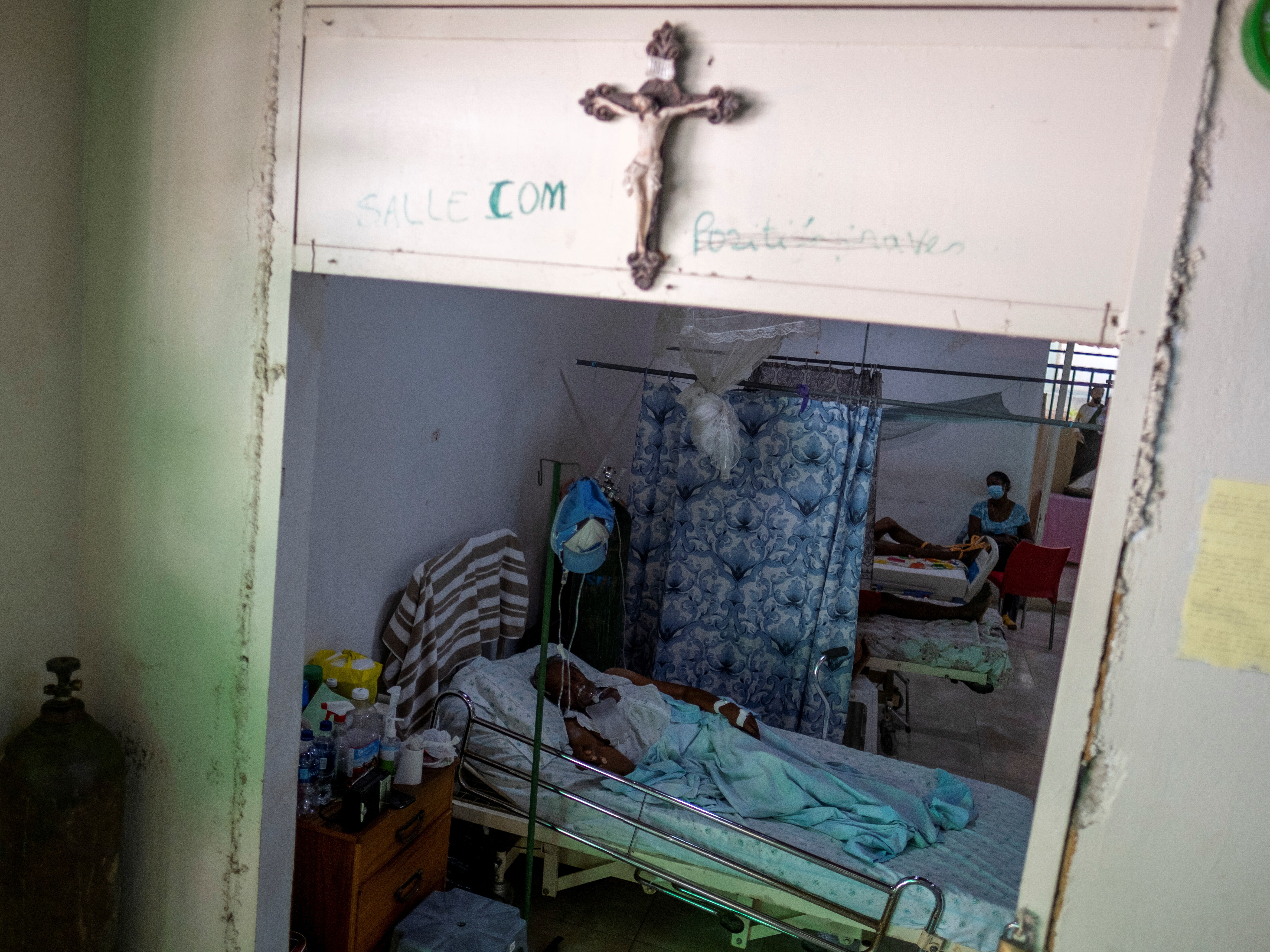 caption: COVID-19 patients receive treatment at the St. Luke Foundation for Haiti hospital in Port-au-Prince, Haiti, on July 16. The country received its first shipment of COVID-19 vaccine doses that month.