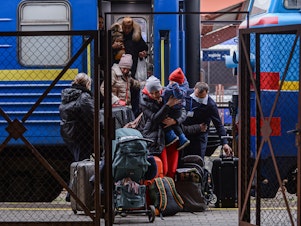 caption: Millions have fled Ukraine, with many coming to Poland through the the Przemysl main train station in Poland.